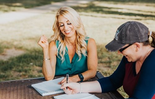 Allison health coach working with a client at a table