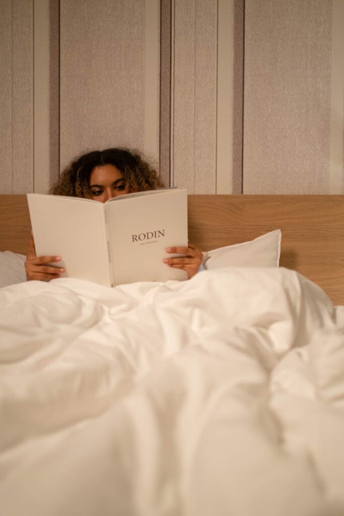 a woman reading on a bed